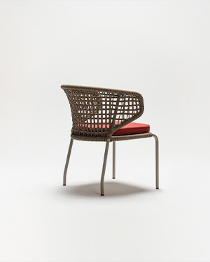 Metal and hand-made rope intertwine, crafting a chair that's both artistic and inviting.DUBAN ARMCHAIR