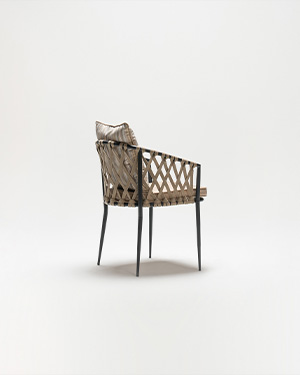 Metal and hand-made rope intertwine, crafting a seat that blends elegance with relaxation.PENA ARMCHAIR